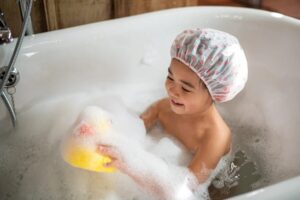 A lukewarm bath before bed can help lower your child’s body temperature, making it easier for them to fall asleep.